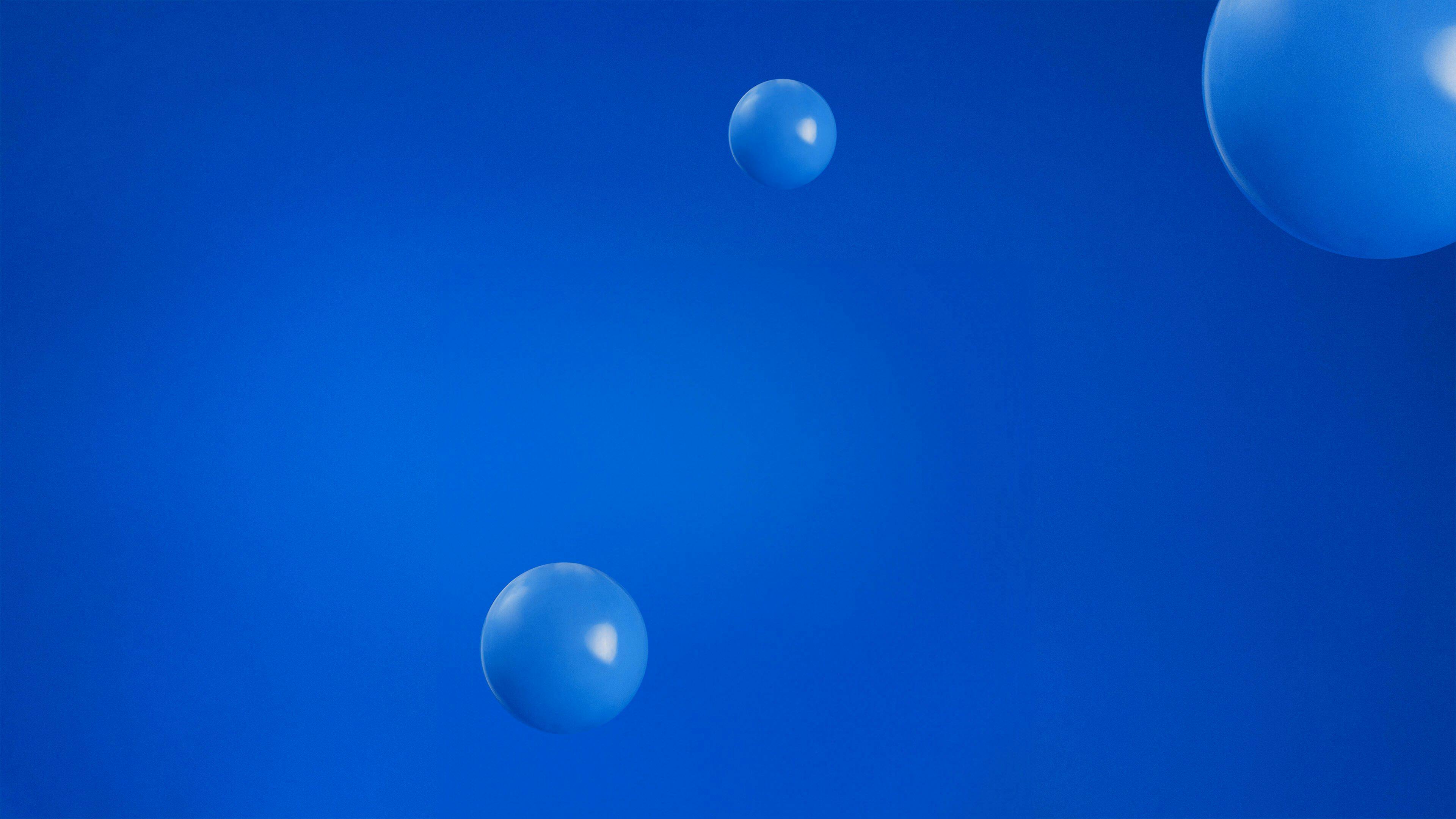 A smooth and subtle background image featuring blue, spherical balloons